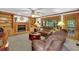 Relaxing living room features a fireplace, built-in shelves, and plush brown reclining furniture at 4373 Mikandy Nw Dr, Kennesaw, GA 30144
