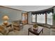 Comfortable living area with plush seating, large windows, and warm, neutral decor at 4373 Mikandy Nw Dr, Kennesaw, GA 30144