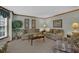 Cozy living room features neutral carpet and trim, comfortable seating, and natural light at 4373 Mikandy Nw Dr, Kennesaw, GA 30144