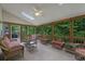 Relaxing screened porch with skylights, ceiling fan, and tranquil view of the backyard's wooded area at 4373 Mikandy Nw Dr, Kennesaw, GA 30144