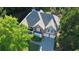 Aerial view of home highlighting brick facade, driveway, and lush surrounding trees at 5004 Lake Mist Se Dr, Mableton, GA 30126