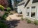 Landscaped backyard featuring paver patio and stone fire pit, perfect for relaxing outdoors and entertaining guests at 5004 Lake Mist Se Dr, Mableton, GA 30126