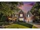 Beautiful two-story brick home featuring an attached two-car garage and a well-manicured lawn at dusk at 5004 Lake Mist Se Dr, Mableton, GA 30126
