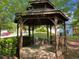 View of the backyard gazebo with swing, creating a serene retreat to relax and enjoy the outdoors at 5004 Lake Mist Se Dr, Mableton, GA 30126