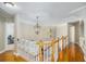 Well-lit hallway with hardwood floors and decorative light fixtures at 5004 Lake Mist Se Dr, Mableton, GA 30126