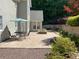 Backyard patio area featuring a stone fire pit, patio dining set, and beautiful landscaping on the upper tier at 5004 Lake Mist Se Dr, Smyrna, GA 30126