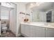 A bathroom with a large mirror, a double vanity, a toilet, and a shower with white tile at 5004 Lake Mist Se Dr, Smyrna, GA 30126