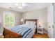 A cozy bedroom featuring a ceiling fan, window with shutters, and a comfortable bed with side tables at 5004 Lake Mist Se Dr, Smyrna, GA 30126