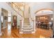 Spacious foyer with gleaming hardwood floors, staircase, and views into dining and living areas at 5004 Lake Mist Se Dr, Smyrna, GA 30126