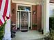 Inviting front entrance with a wreath, classic brick facade, and elegant outdoor lighting at 5004 Lake Mist Se Dr, Smyrna, GA 30126
