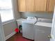 A laundry room equipped with a washer, dryer, utility sink, wood-look flooring, and natural light at 5004 Lake Mist Se Dr, Smyrna, GA 30126
