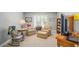A cozy living room featuring two floral chairs, side tables, a lamp, and a rocking chair with a TV at 5004 Lake Mist Se Dr, Smyrna, GA 30126