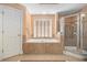Spacious main bathroom features a soaking tub, separate shower, and tile floors at 5004 Lake Mist Se Dr, Smyrna, GA 30126