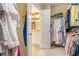 View of an organized walk-in closet with clothes and an ensuite bathroom, showing an organized layout at 5004 Lake Mist Se Dr, Smyrna, GA 30126