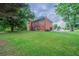 Expansive backyard with a lush green lawn and large brick home at 5610 Mountain Meadow Ct, Stone Mountain, GA 30087