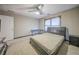 Bedroom with a ceiling fan, carpeted floors, and a window providing natural light at 5610 Mountain Meadow Ct, Stone Mountain, GA 30087