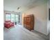 Cozy bedroom featuring carpet floors, large windows, comfortable seating, and built in shelving at 5610 Mountain Meadow Ct, Stone Mountain, GA 30087