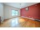 Spacious bedroom with hardwood floors, a large window, and neutral wall colors at 5610 Mountain Meadow Ct, Stone Mountain, GA 30087