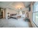 Spacious main bedroom featuring carpet floors, ceiling fan, tray ceiling, and large picture window at 5610 Mountain Meadow Ct, Stone Mountain, GA 30087