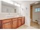 Bright bathroom features a double sink vanity with granite countertop and a large mirror at , Mableton, GA 30126