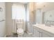 White bathroom with toilet, vanity, mirror, and frosted window at , Mableton, GA 30126