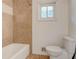 Bright bathroom with a shower and tub combination and a tiled accent wall at , Mableton, GA 30126