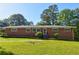 Charming brick home featuring a well-manicured lawn and mature trees at , Mableton, GA 30126