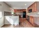Well-equipped kitchen with stainless steel appliances, dark wood cabinetry, and mosaic backsplash at , Mableton, GA 30126
