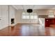 Open floor plan showcasing a fireplace, modern lighting, and hardwood floors at , Mableton, GA 30126