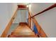 Wooden stairs with white walls and wooden handrail leading down to the basement at , Mableton, GA 30126