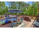 Backyard deck with a pool, outdoor furniture, and mature trees, perfect for outdoor living at 173 Avalon Way, Riverdale, GA 30274