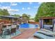 The backyard offers a pool, hot tub, deck, and outdoor seating, great for entertaining and relaxing at 173 Avalon Way, Riverdale, GA 30274