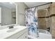 This bathroom features a tub shower, a white vanity with silver hardware, and tile walls at 173 Avalon Way, Riverdale, GA 30274