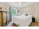 Cozy bedroom with neutral walls, ceiling fan, carpet, and ample natural light from a large window at 173 Avalon Way, Riverdale, GA 30274