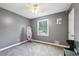 This bedroom features gray walls, neutral carpet, a ceiling fan, a window, and a painted mirror at 173 Avalon Way, Riverdale, GA 30274