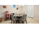 This dining area features seating for four, a popcorn machine, and tile flooring at 173 Avalon Way, Riverdale, GA 30274