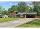 Charming home featuring a covered driveway, complemented by a lush green lawn at 173 Avalon Way, Riverdale, GA 30274