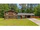 Charming split-level home with a well-manicured lawn, attached carport, and inviting blue front door at 173 Avalon Way, Riverdale, GA 30274