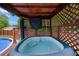Inviting hot tub features a wooden privacy enclosure, perfect for relaxation and outdoor enjoyment at 173 Avalon Way, Riverdale, GA 30274