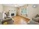 This living room has hardwood floors, a modern fireplace, neutral walls, and lots of light from the window at 173 Avalon Way, Riverdale, GA 30274
