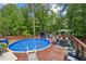 Enjoy the outdoors with this in-ground pool, surrounding deck, and mature trees at 173 Avalon Way, Riverdale, GA 30274