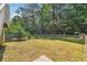 Landscaped backyard with wooden fence, mature trees and green lawn perfect for pets and outdoor activities at 1820 Habersham Gate Dr, Cumming, GA 30041