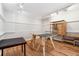 Basement area with wood flooring, storage shelves, and track lighting; perfect for hobbies at 1820 Habersham Gate Dr, Cumming, GA 30041
