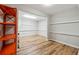 Finished basement with wood-look flooring, shelving, and a bright, open space at 1820 Habersham Gate Dr, Cumming, GA 30041
