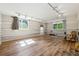 Spacious basement with wood floor, natural light, track lights and neutral colored walls at 1820 Habersham Gate Dr, Cumming, GA 30041