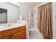 Bright bathroom featuring a vanity, toilet, and a bathtub with shower, complete with neutral-toned decor at 1820 Habersham Gate Dr, Cumming, GA 30041