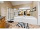 Primary bath featuring a soaking tub, standing shower, and double vanity sinks at 1820 Habersham Gate Dr, Cumming, GA 30041