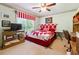 Cozy bedroom with bright red and white accents, featuring a comfy bed, TV, and natural light at 1820 Habersham Gate Dr, Cumming, GA 30041