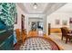 Bright foyer with hardwood floors, decorative rug and an open view into the living spaces at 1820 Habersham Gate Dr, Cumming, GA 30041