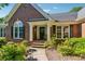 Charming brick home featuring a welcoming entrance, complete with lovely wreath and well-maintained landscaping at 1820 Habersham Gate Dr, Cumming, GA 30041